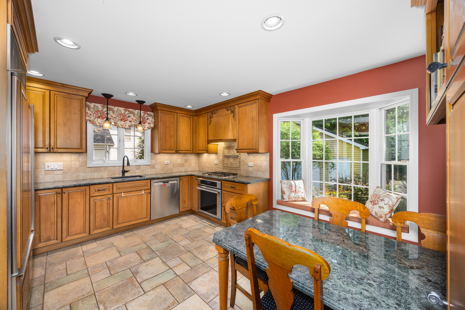 715 Smoke Tree Road Deerfield, IL 60015 - Photo 14 of 41 a kitchen with stainless steel appliances granite countertop a stove a sink and a refrigerator
