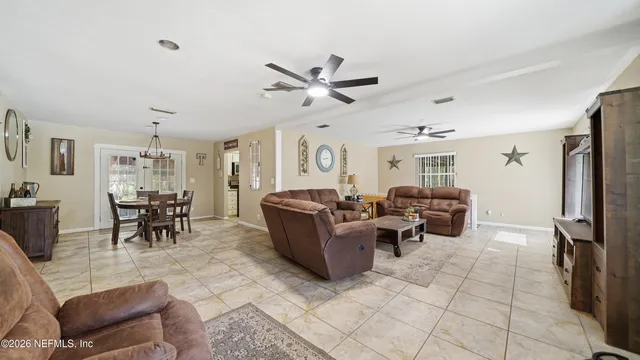 a living room with furniture and a clock