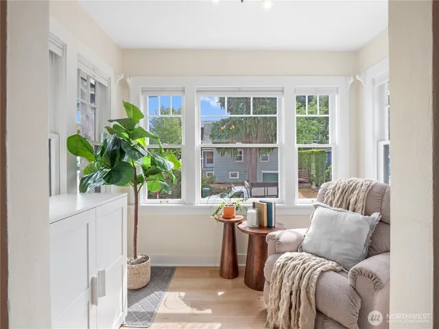 a living room with furniture and a potted plant