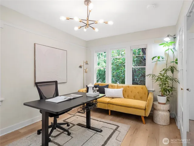 a living room with furniture and a potted plant