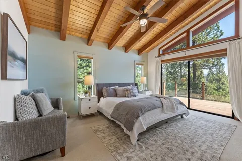 a spacious bedroom with a bed and a large window