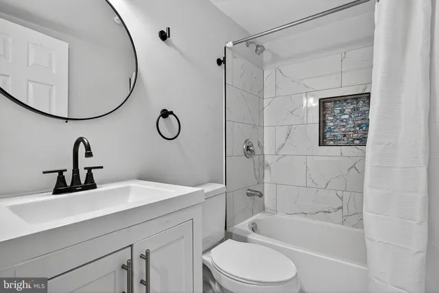 a bathroom with a sink a toilet and a mirror