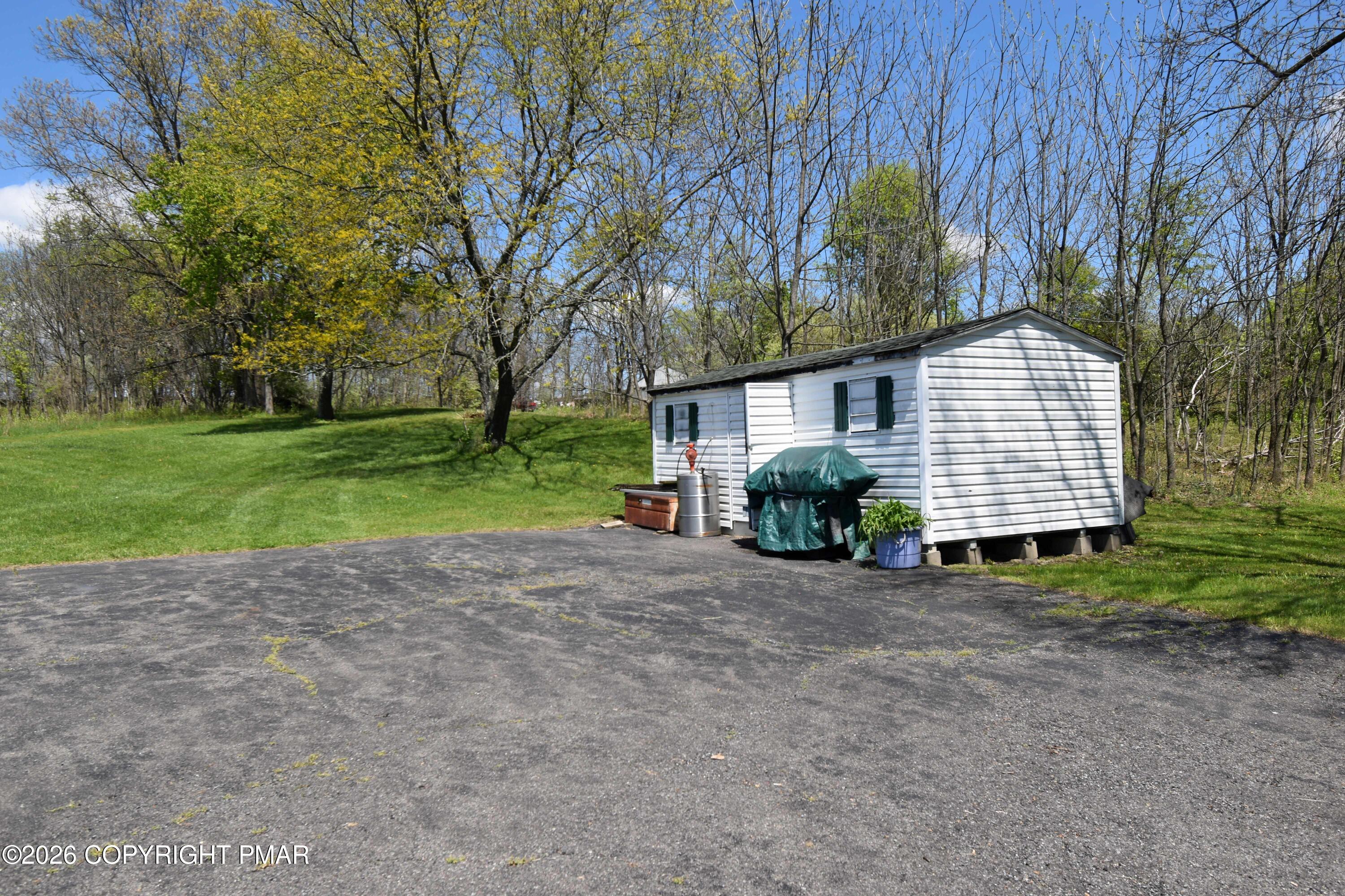 160 Quiet Valley Road Mount Bethel, PA 18343 - Photo 40 of 44 a front view of a house with a yard and garage