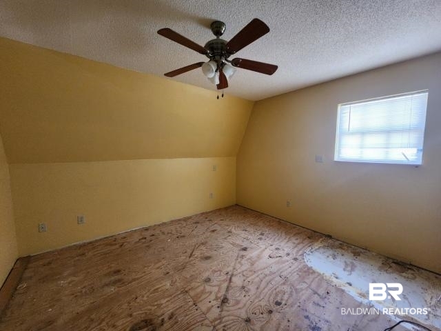 32749 Antietam Road Lillian, AL 36549 - Photo 25 of 47 Additional living space featuring a textured ceiling, ceiling fan, and lofted ceiling