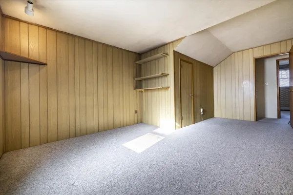 a view of a room with a wooden walls