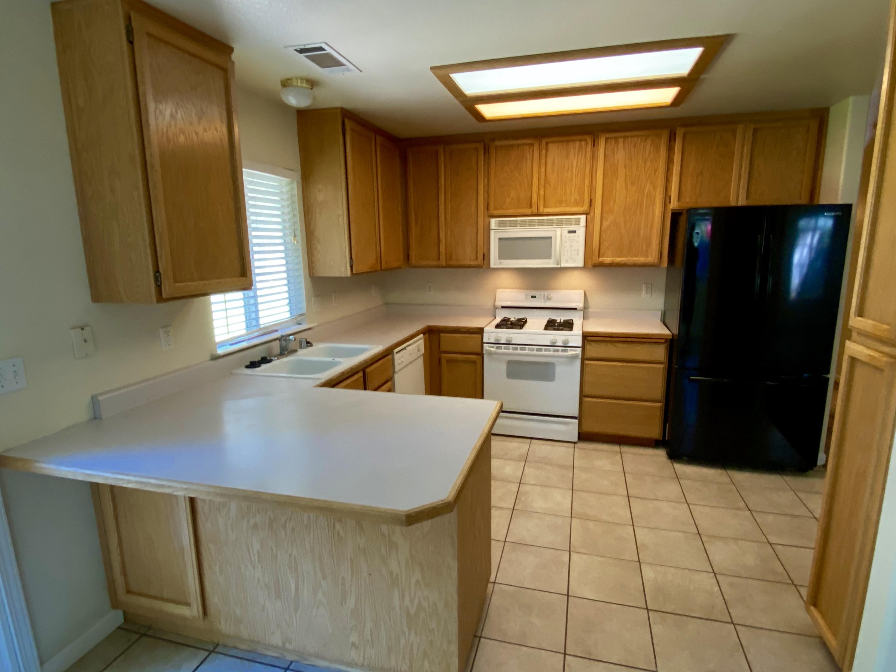 5378 Cedars Road Redding, CA 96001 - Photo 1 of 23 a kitchen with a sink a refrigerator and cabinets