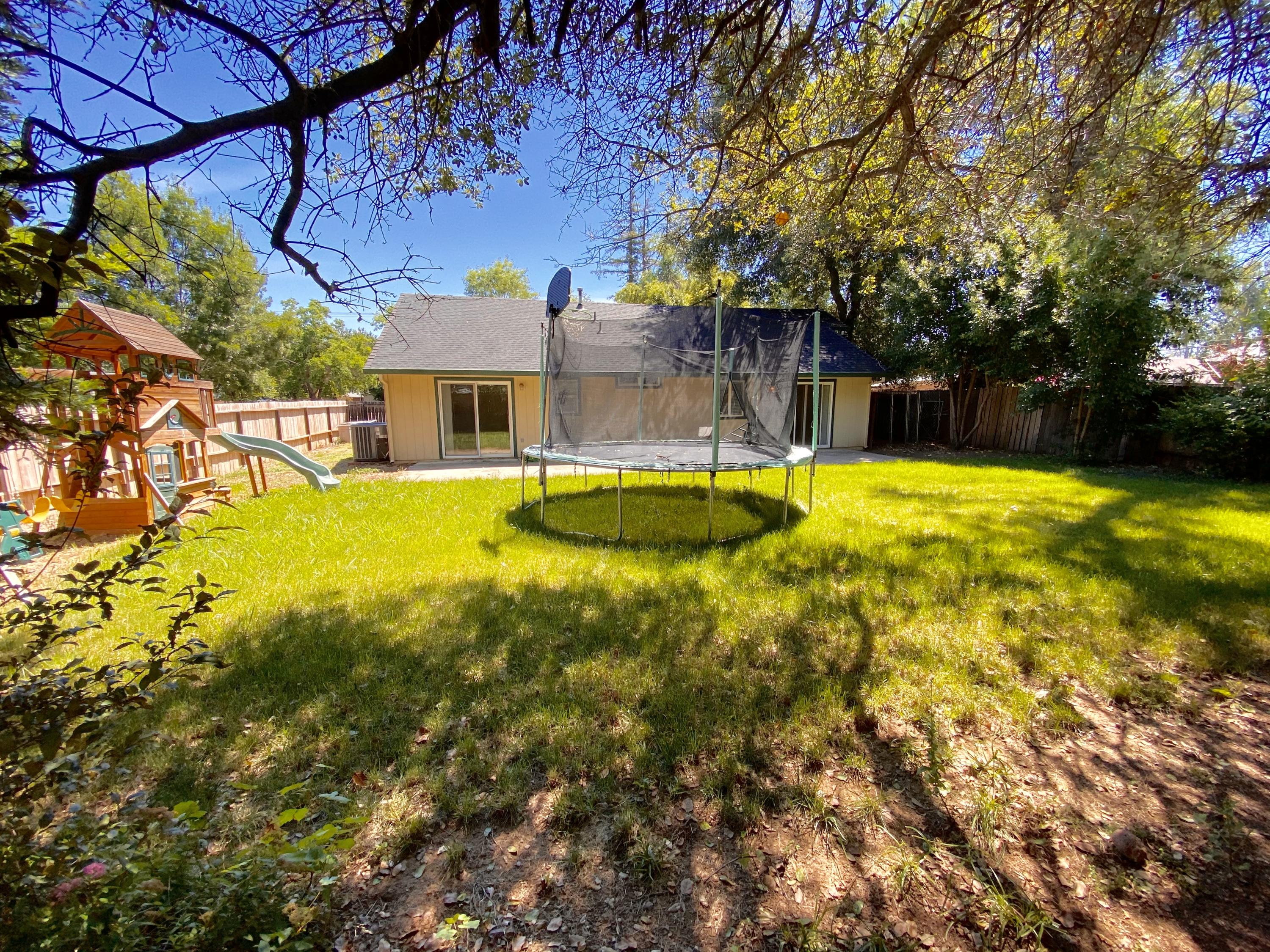 5378 Cedars Road Redding, CA 96001 - Photo 22 of 23 a view of a swimming pool with lawn chairs and plants