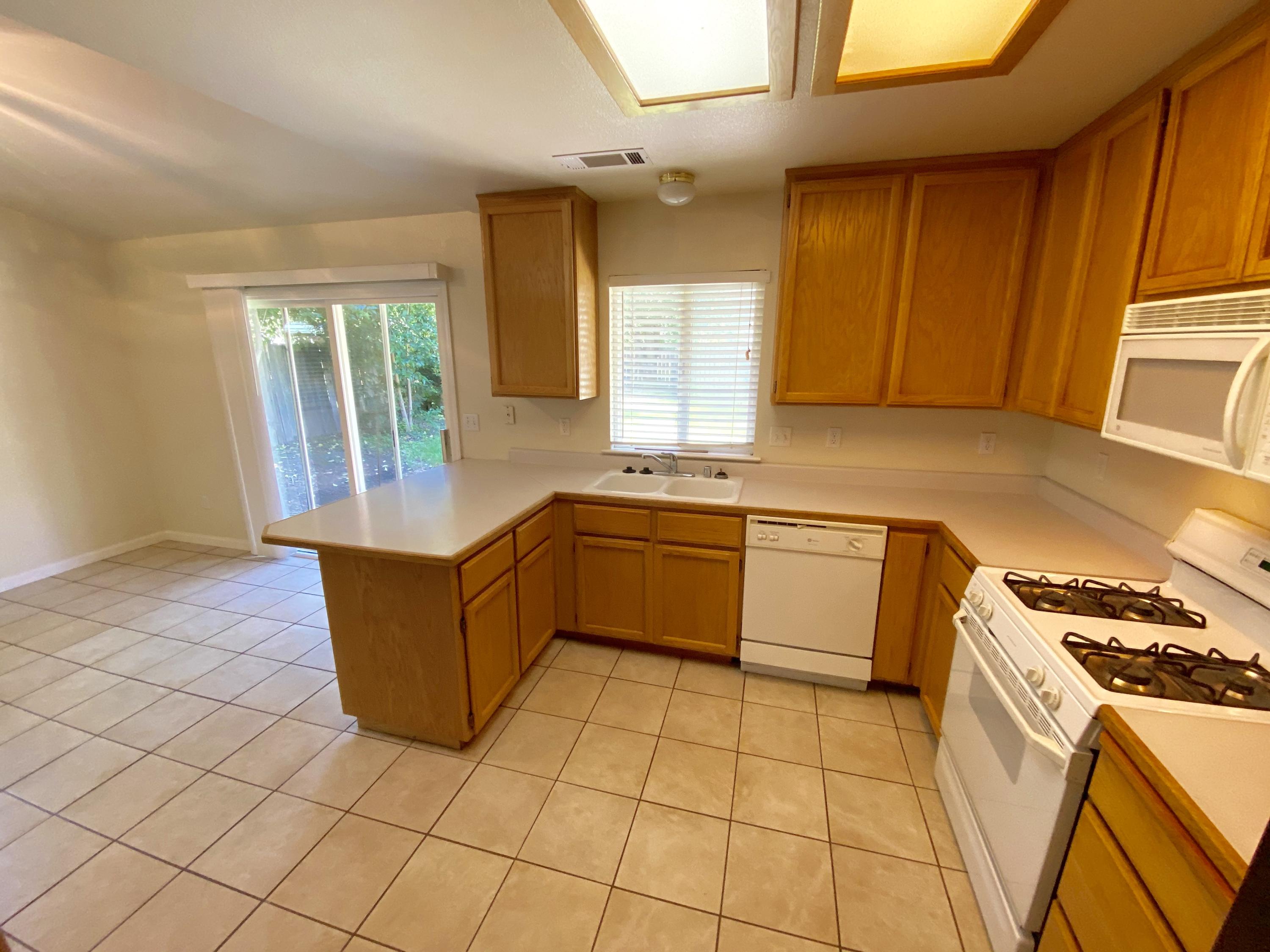 5378 Cedars Road Redding, CA 96001 - Photo 6 of 23 a kitchen with stainless steel appliances granite countertop a stove a sink and a microwave