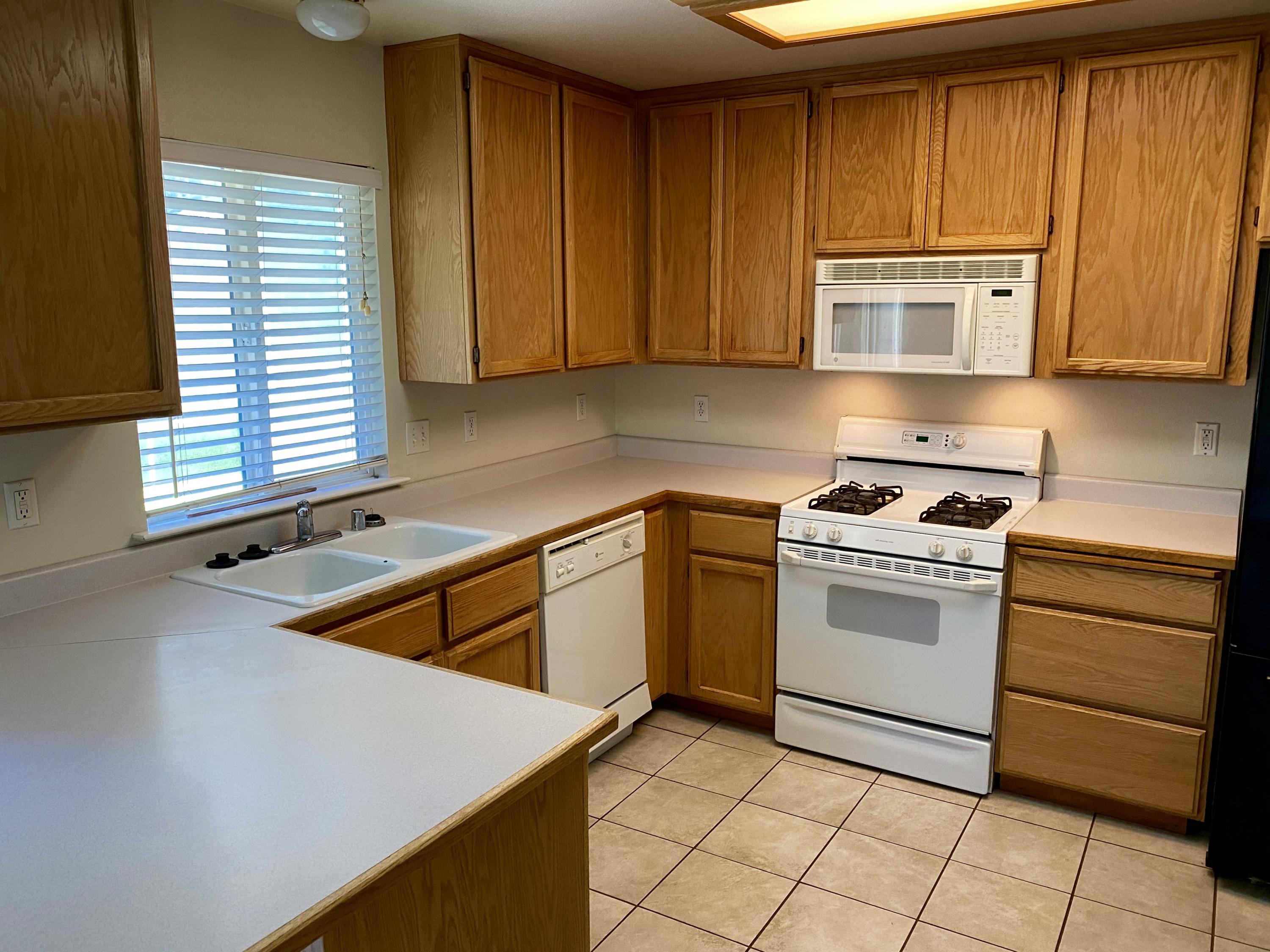 5378 Cedars Road Redding, CA 96001 - Photo 7 of 23 a kitchen with cabinets and appliances