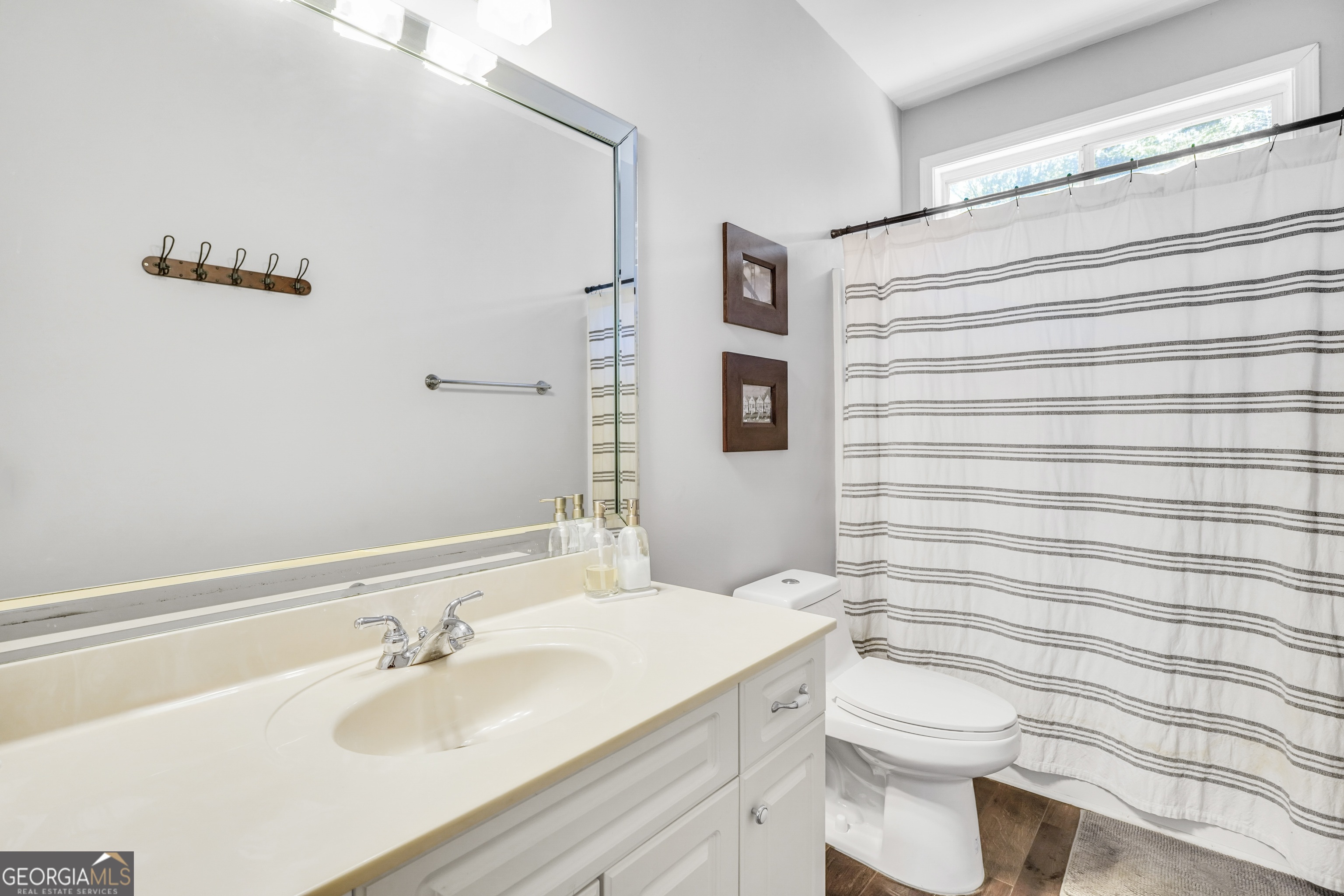 261 Highway 85 Connector Brooks, GA 30205 - Photo 35 of 73 a bathroom with a sink a toilet and shower curtain