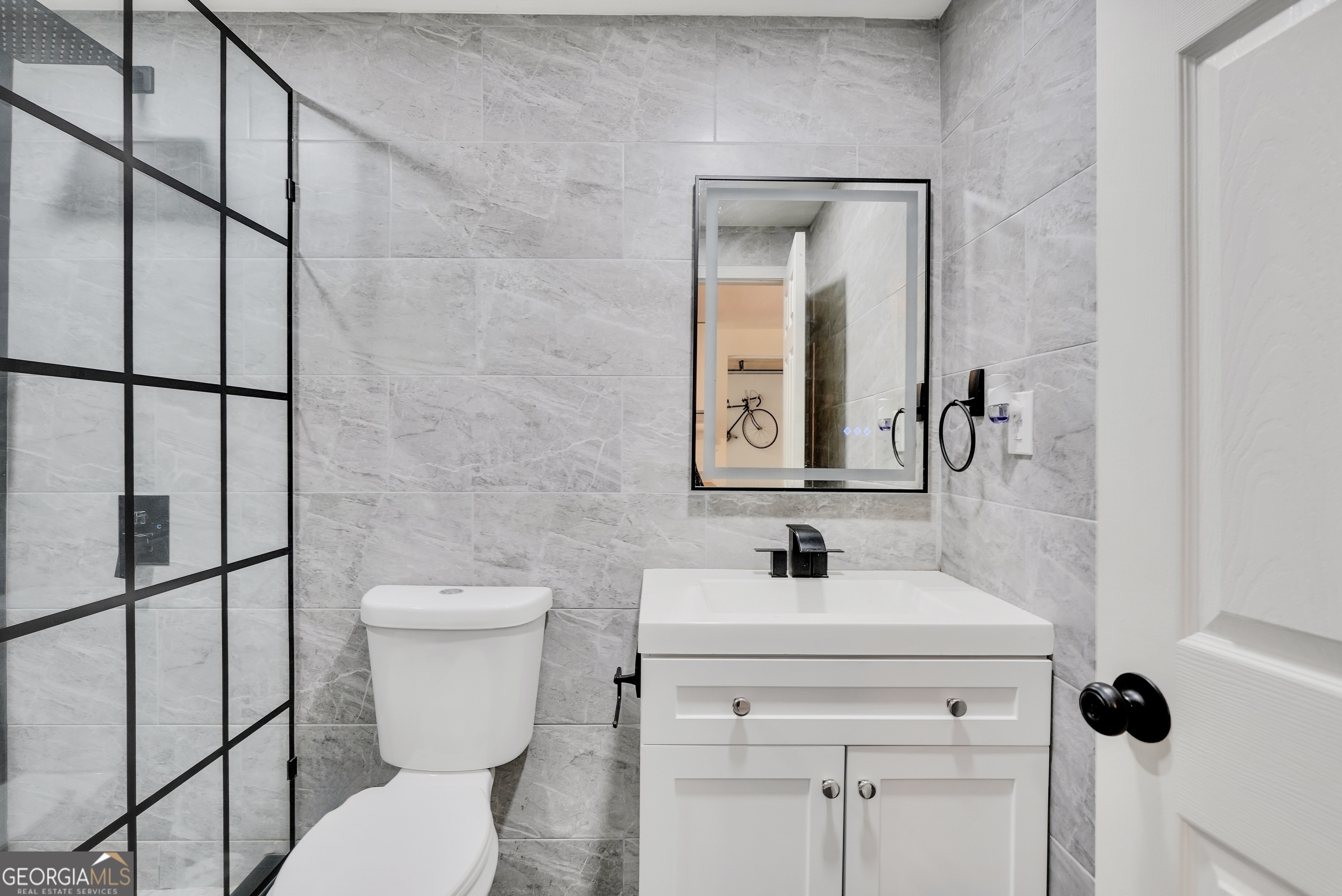 261 Highway 85 Connector Brooks, GA 30205 - Photo 42 of 73 a bathroom with a toilet sink and mirror