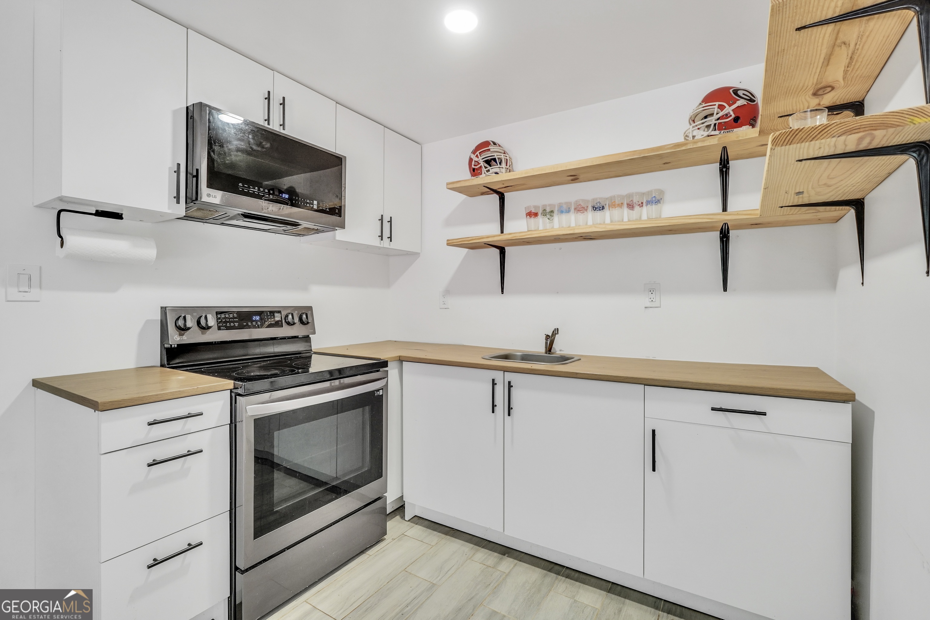 261 Highway 85 Connector Brooks, GA 30205 - Photo 47 of 73 a kitchen with stainless steel appliances granite countertop a sink and a stove