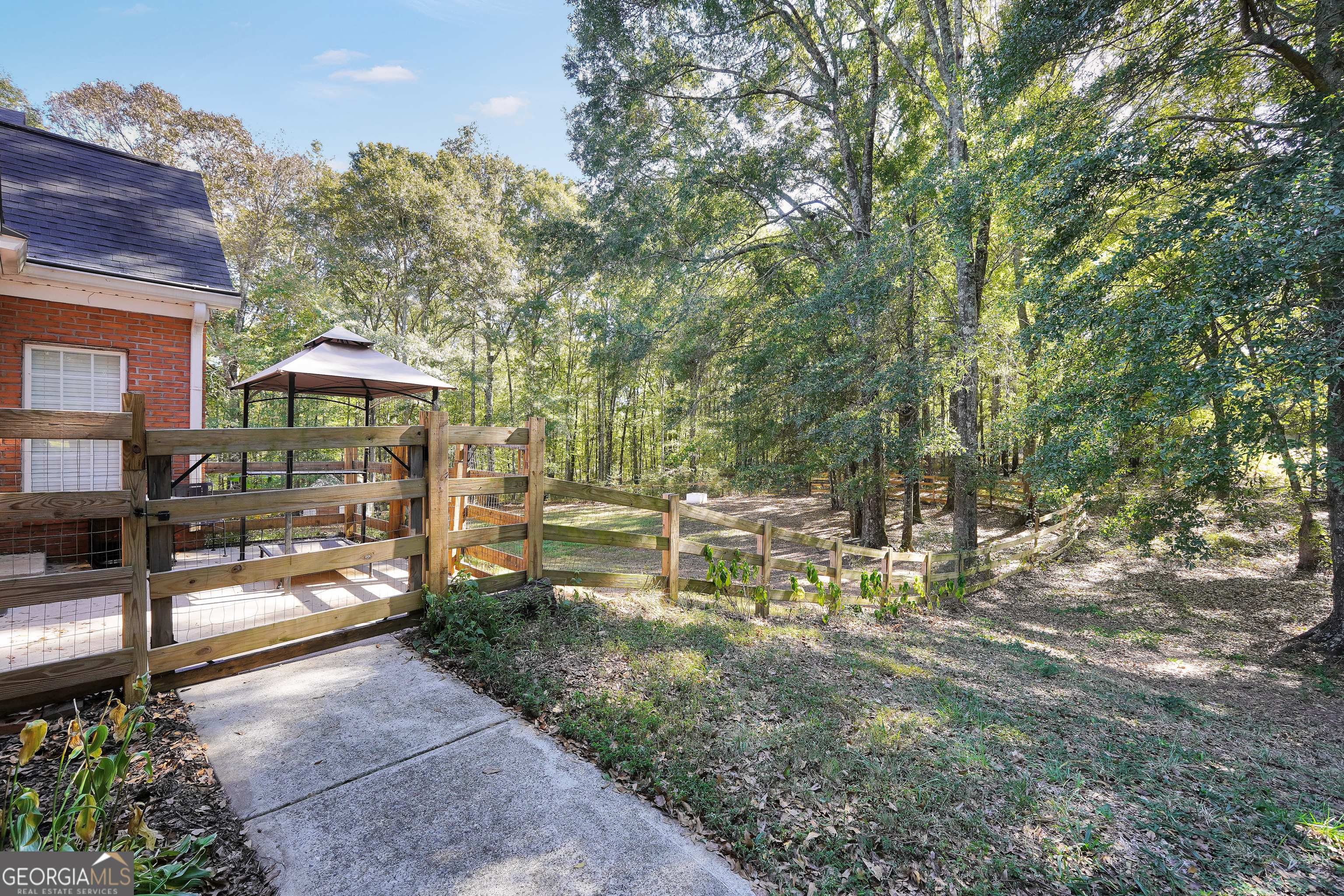 261 Highway 85 Connector Brooks, GA 30205 - Photo 69 of 73 a view of a patio with table and chairs potted plants and large tree