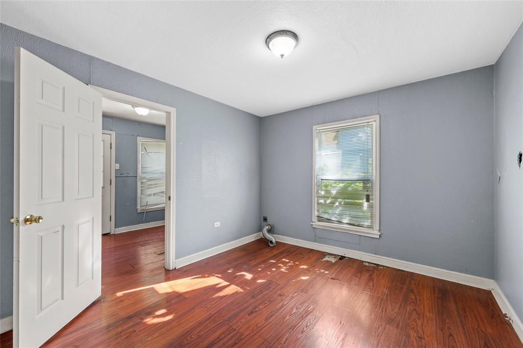 2225 Mitchell Avenue Waco, TX 76708 - Photo 4 of 16 Interior space with wood-finish flooring, light blue wall paint, and white trim molding