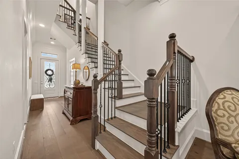 a view of entryway and hall with wooden floor