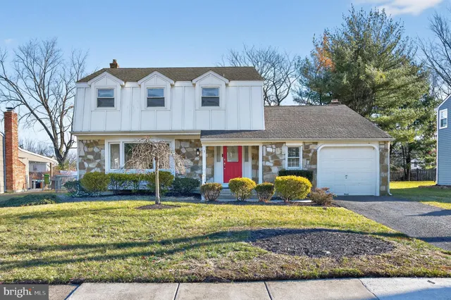 front view of a brick house with a yard