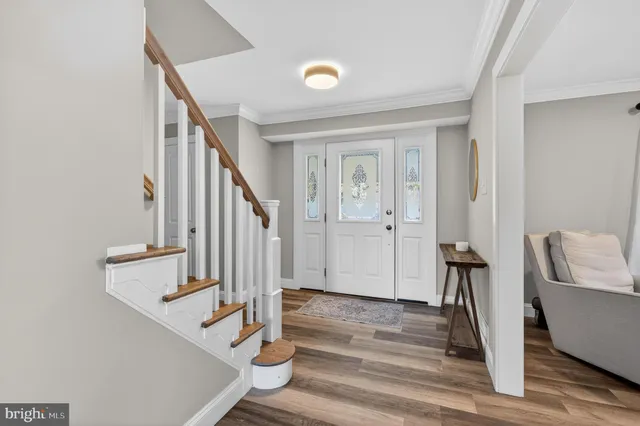 a view of entryway and hall with wooden floor