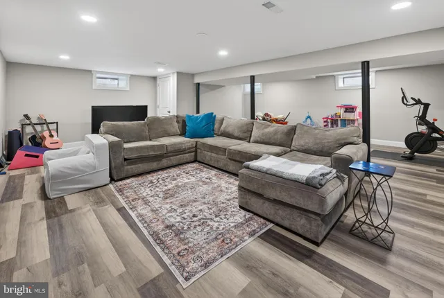a living room with furniture and a rug