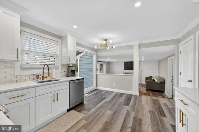 a large white kitchen with a large window