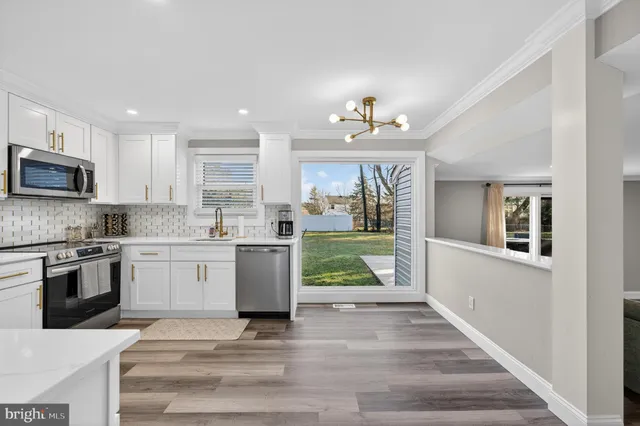a kitchen with a refrigerator and a sink