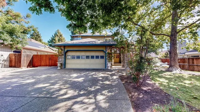 a view of a house with a tree and a yard
