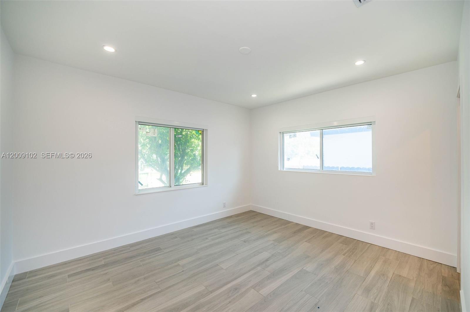 330 Southwest 27th Road Miami, FL 33129 - Photo 15 of 62 an empty room with wooden floor and windows