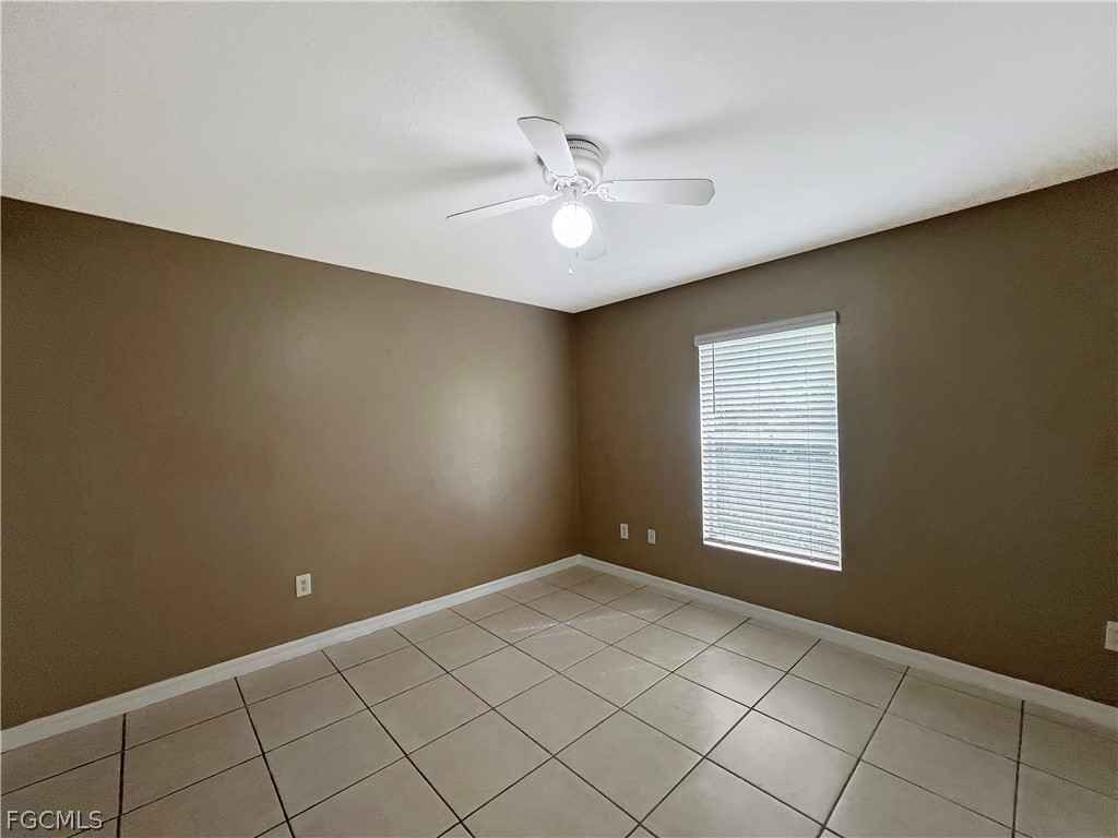 5231 27th Street Southwest Lehigh Acres, FL 33973 - Photo 12 of 22 an empty room with windows and fan