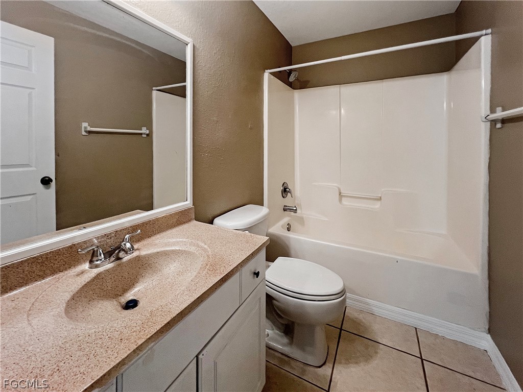 5231 27th Street Southwest Lehigh Acres, FL 33973 - Photo 13 of 22 a bathroom with a sink toilet and shower