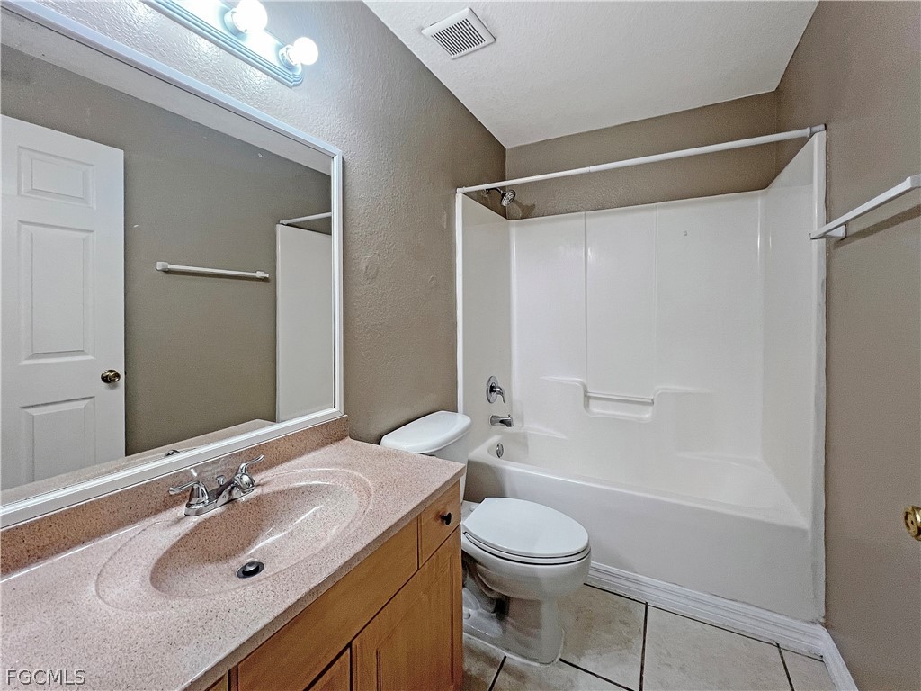 5231 27th Street Southwest Lehigh Acres, FL 33973 - Photo 16 of 22 a bathroom with a sink a toilet and shower