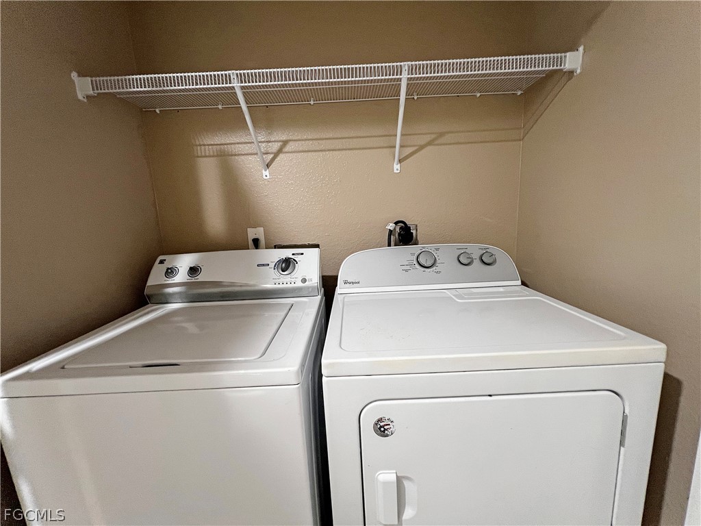 5231 27th Street Southwest Lehigh Acres, FL 33973 - Photo 19 of 22 a utility room with dryer and washer