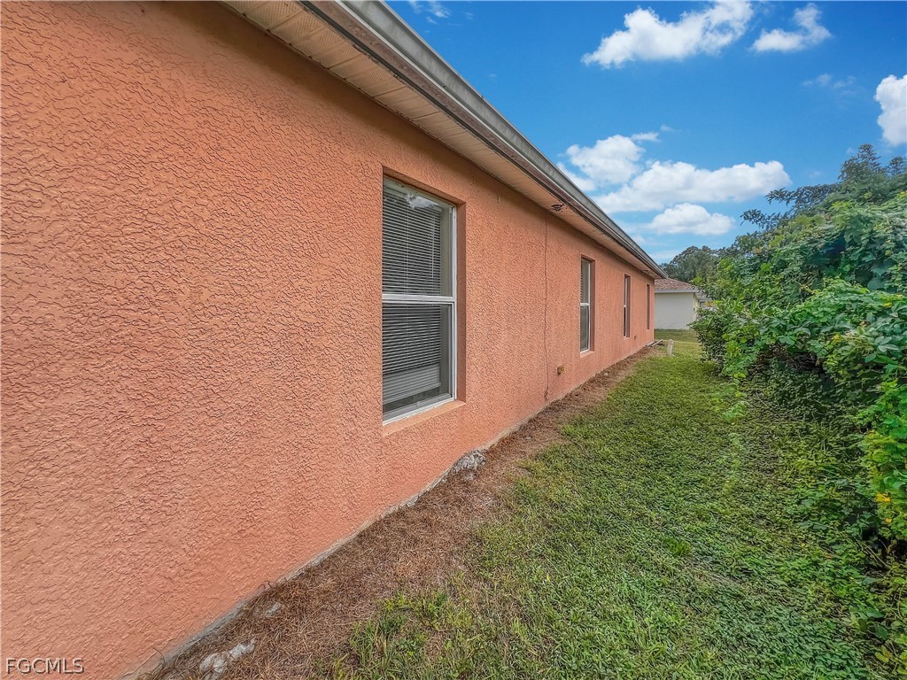 5231 27th Street Southwest Lehigh Acres, FL 33973 - Photo 21 of 22 a view of a backyard of the house