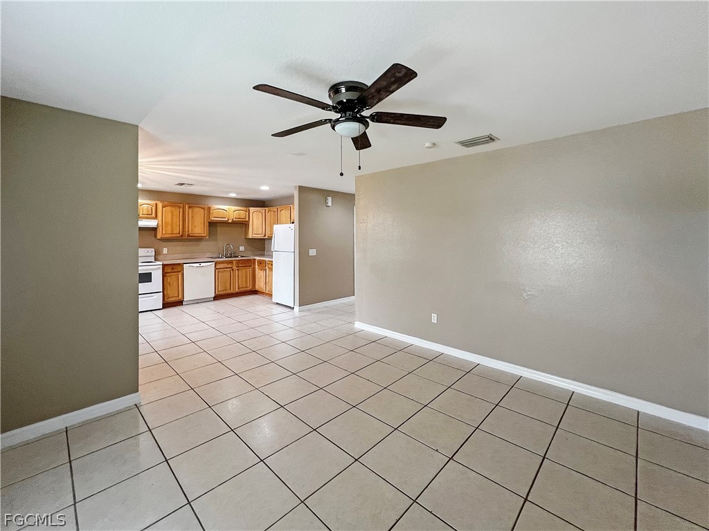 5231 27th Street Southwest Lehigh Acres, FL 33973 - Photo 7 of 22 a very nice looking room with a ceiling fan