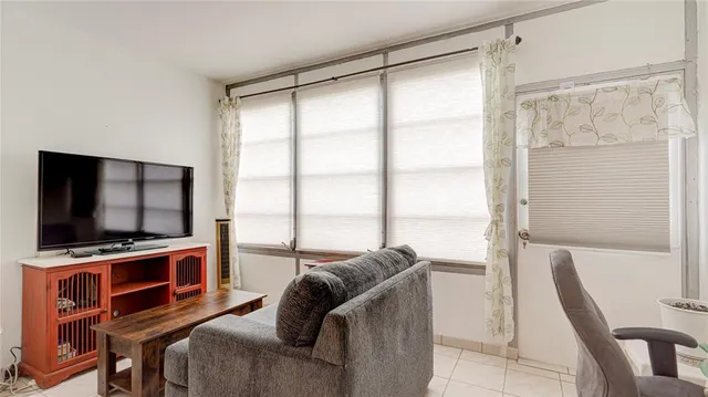 a bedroom with furniture and a flat screen tv