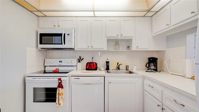 a kitchen with stainless steel appliances white cabinets and a sink