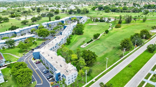 an aerial view of residential houses with outdoor space and trees