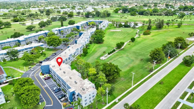 an aerial view of residential houses with outdoor space and street view