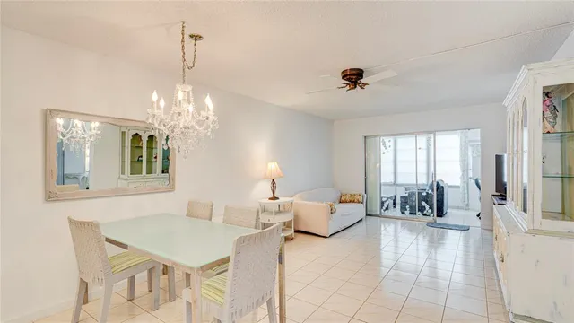 a living room with fireplace furniture and a chandelier