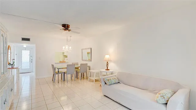 a living room with furniture a dining table and a piano