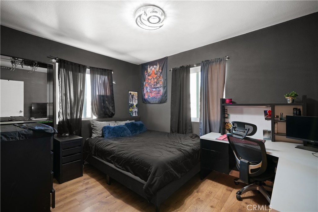 18859 6th Street Bloomington, CA 92316 - Photo 17 of 31 a bedroom with a bed and a television