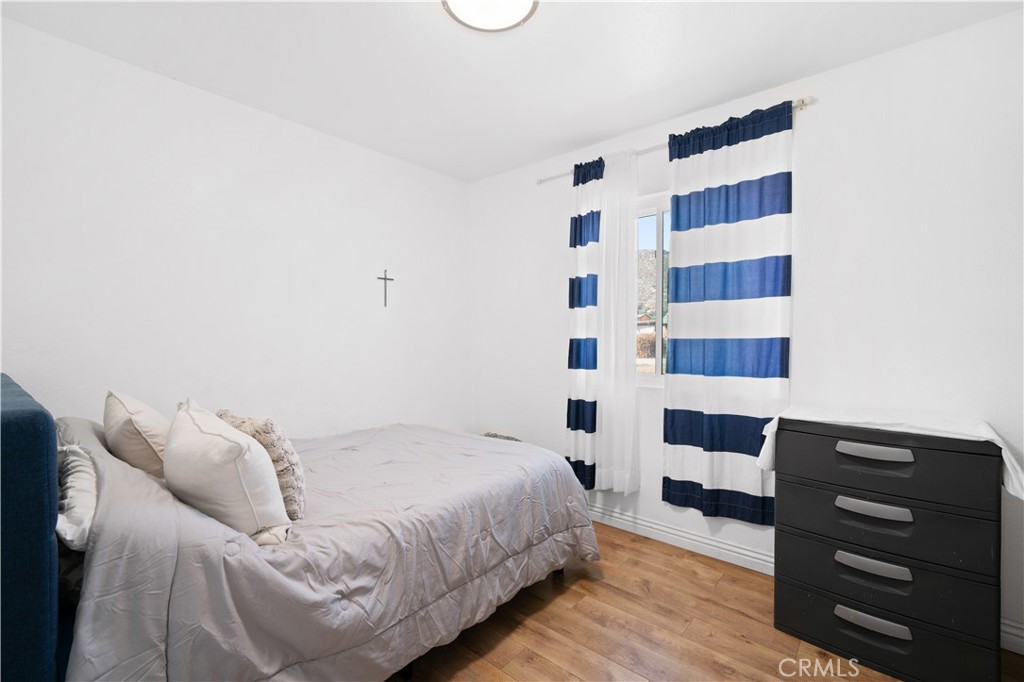 18859 6th Street Bloomington, CA 92316 - Photo 20 of 31 a bedroom with a bed and a cabinets