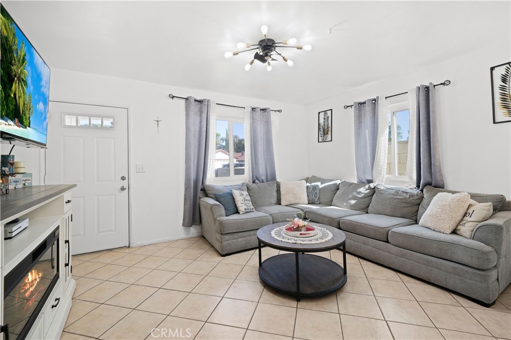 18859 6th Street Bloomington, CA 92316 - Photo 5 of 31 a living room with furniture and a fireplace