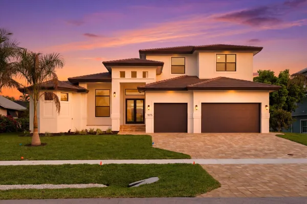 a front view of a house with a yard and garage