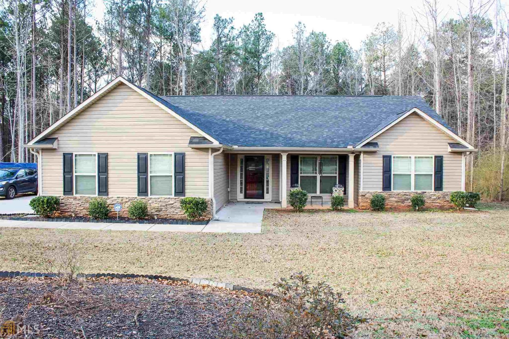 121 Lamb Road Moreland, GA 30259 - Photo 1 of 1 a front view of a house with a yard and outdoor seating