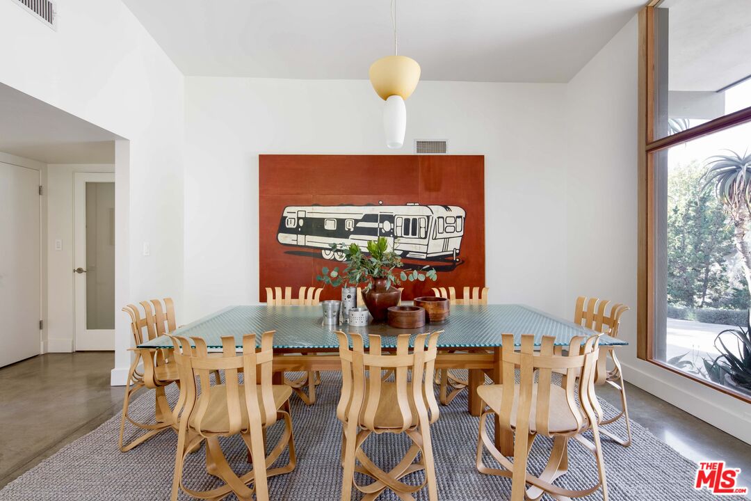 7500 Devista Drive Los Angeles, CA 90046 - Photo 17 of 41 a view of a dining room with furniture a chandelier and wooden floor