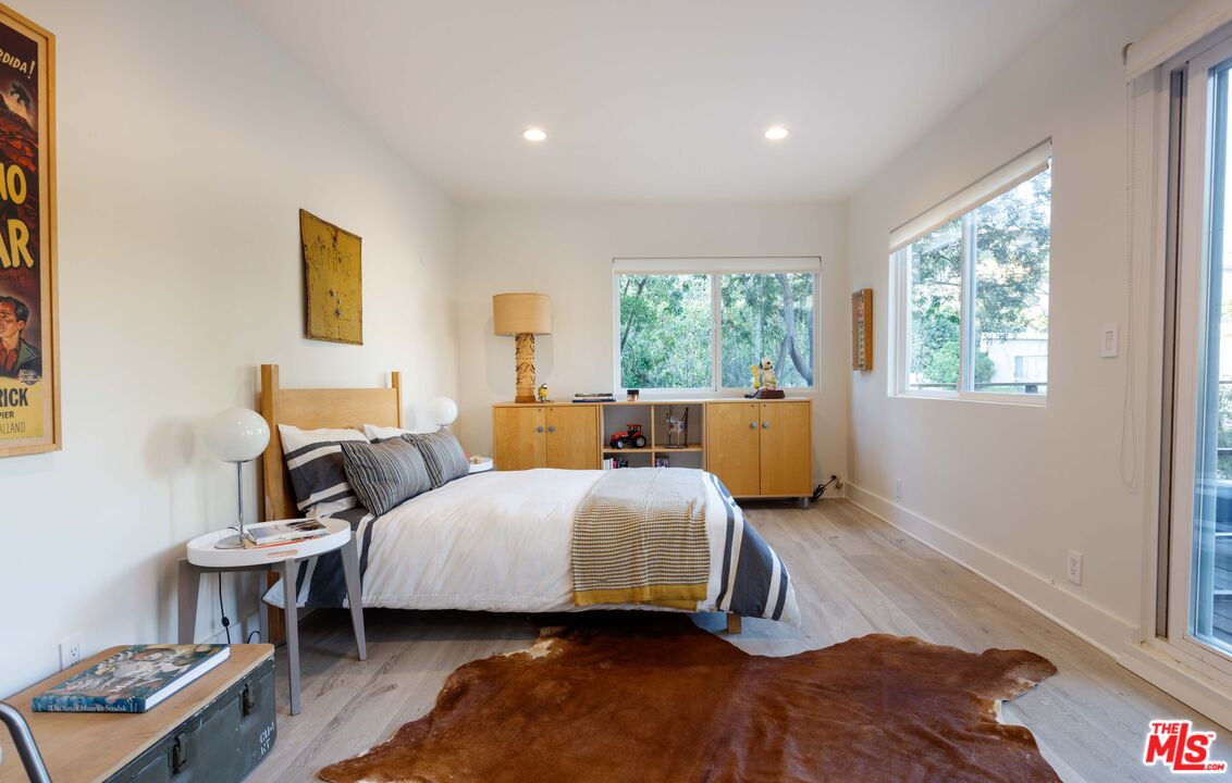 7500 Devista Drive Los Angeles, CA 90046 - Photo 28 of 41 a bedroom with a bed and wooden floor