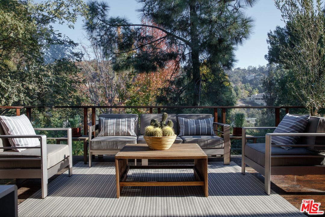 7500 Devista Drive Los Angeles, CA 90046 - Photo 34 of 41 a roof deck with table and chairs a barbeque and a potted plant