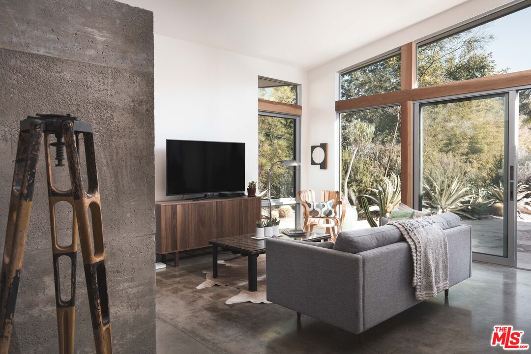 7500 Devista Drive Los Angeles, CA 90046 - Photo 10 of 41 a living room with furniture a large window and a flat screen tv