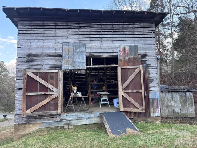 a view of house with yard and sitting area