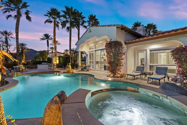 an aerial view of a house with swimming pool garden and outdoor seating