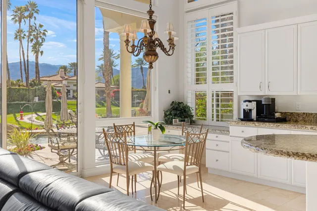 a view of a dining room with furniture and a potted plant